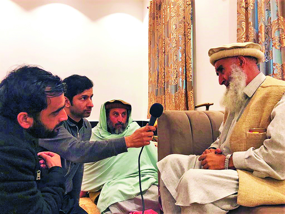 Waleed Ziad (second from left) interviewing an elder of the Naqshbandi Sufi order in Thana, Malakand.